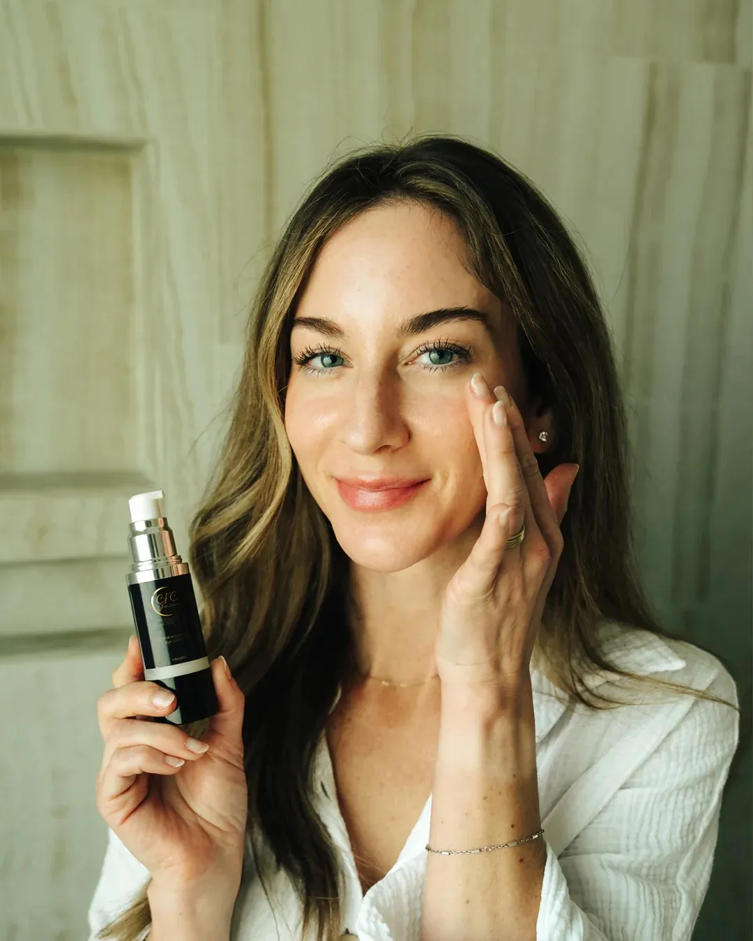 Woman at sink with CFC skincare routine